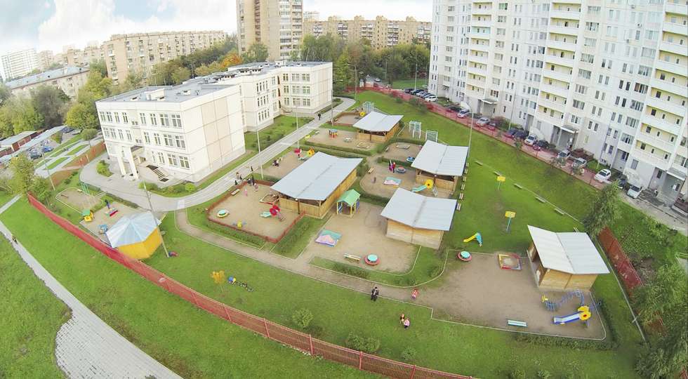 Kindergarten with playground near residential complex